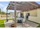 Landscaped patio area with dining furniture beneath a shaded pergola and decorative string lights at 4618 E Valley View Dr, Phoenix, AZ 85044