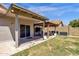 This backyard has a covered patio and a small yard at 4633 E Desert Cactus St, Phoenix, AZ 85032