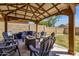 This backyard features an outdoor patio with a sitting area and lights at 4633 E Desert Cactus St, Phoenix, AZ 85032