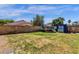 Spacious backyard featuring a block wall, trampoline, shed, and basketball hoop at 4633 E Desert Cactus St, Phoenix, AZ 85032