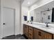Modern bathroom with wood cabinets, double sinks, and a walk-in shower at 4633 E Desert Cactus St, Phoenix, AZ 85032