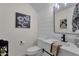 Stylish bathroom with a modern vanity, decorative mirror, and neutral color palette at 4633 E Desert Cactus St, Phoenix, AZ 85032