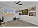 This carpeted bedroom has a ceiling fan and a window at 4633 E Desert Cactus St, Phoenix, AZ 85032
