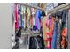 Walk-in closet filled with a variety of clothing items and storage options at 4633 E Desert Cactus St, Phoenix, AZ 85032