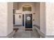 Front door entrance with sidelight windows and a welcome mat at 4633 E Desert Cactus St, Phoenix, AZ 85032