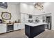 Contemporary kitchen featuring an island, sleek appliances, and ample cabinet space at 4633 E Desert Cactus St, Phoenix, AZ 85032