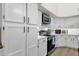 Well-lit kitchen featuring white cabinets, modern appliances, and ample counter space at 4633 E Desert Cactus St, Phoenix, AZ 85032