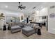 Bright and airy living room with an open layout and a modern kitchen in the background at 4633 E Desert Cactus St, Phoenix, AZ 85032