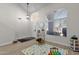 Bright living space with large windows, light wood flooring, and neutral paint at 4633 E Desert Cactus St, Phoenix, AZ 85032