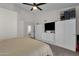 Bright main bedroom with closet storage, ceiling fan, and carpeted floors at 4633 E Desert Cactus St, Phoenix, AZ 85032