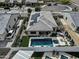 A beautiful aerial of a backyard with a pool, turf, landscaping and an outdoor kitchen, and solar panels on the home at 5951 N 190Th Dr, Litchfield Park, AZ 85340
