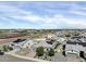 This is an aerial view of a residential neighborhood with solar panels, landscaping, and a community area in the background at 5951 N 190Th Dr, Litchfield Park, AZ 85340