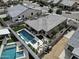 Aerial view of backyard featuring a stunning pool with spa, patio area with fire pit, and well-manicured artificial lawn at 5951 N 190Th Dr, Litchfield Park, AZ 85340