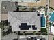 An aerial view shows a house with a tile roof, solar panels, a pool, a spa, and an outdoor dining area at 5951 N 190Th Dr, Litchfield Park, AZ 85340