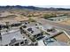 This aerial view captures an upscale home with a pool, spa, solar panels, desert landscaping, and mountain views at 5951 N 190Th Dr, Litchfield Park, AZ 85340