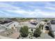 A beautiful aerial view of a single Gathering home with desert landscaping and solar panels in a well-planned community at 5951 N 190Th Dr, Litchfield Park, AZ 85340