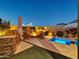 Backyard features a built-in grill, cozy fire pit, and inviting spa, perfect for relaxing evenings at 5951 N 190Th Dr, Litchfield Park, AZ 85340