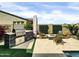 Outdoor kitchen and BBQ area with a fire pit, perfect for entertaining at 5951 N 190Th Dr, Litchfield Park, AZ 85340