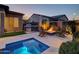 Relaxing backyard with built-in grill, fire pit, lounge chairs, and inviting spa, perfect for outdoor living at 5951 N 190Th Dr, Litchfield Park, AZ 85340