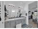Modern bathroom with double vanity, mosaic tile accents, and sleek lighting fixtures at 5951 N 190Th Dr, Litchfield Park, AZ 85340