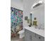 Bright bathroom featuring a colorful shower curtain, modern vanity with a white countertop, and neutral walls at 5951 N 190Th Dr, Litchfield Park, AZ 85340