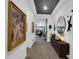 Bright hallway features art, modern lighting, and wood floors, leading to inviting living spaces at 5951 N 190Th Dr, Litchfield Park, AZ 85340