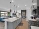 Open concept kitchen with stainless steel appliances, white countertops, and hardwood floors that leads to the living room at 5951 N 190Th Dr, Litchfield Park, AZ 85340