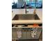 Kitchen sink details featuring storage under the sink, integrated drying rack, and stylish accessories at 5951 N 190Th Dr, Litchfield Park, AZ 85340