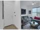 Inviting living room with a comfortable gray sofa, stylish geometric rug, and contemporary decor elements at 5951 N 190Th Dr, Litchfield Park, AZ 85340