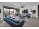 Bright living room with a ceiling fan, hardwood floors, and sliding glass doors to the outdoor pool and patio area at 5951 N 190Th Dr, Litchfield Park, AZ 85340