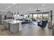 Bright living room with a ceiling fan, hardwood floors, and sliding glass doors to the outdoor pool and patio area at 5951 N 190Th Dr, Litchfield Park, AZ 85340