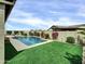 Beautiful backyard oasis featuring a sparkling pool with waterfall features, lush turf, and tasteful landscaping at 5951 N 190Th Dr, Litchfield Park, AZ 85340