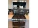 Stainless steel gas range with overhead microwave and sleek backsplash, creating a modern cooking space at 5951 N 190Th Dr, Litchfield Park, AZ 85340