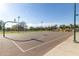 Outdoor basketball court on a sunny day with lush greenery and mature trees at 632 W Natal Cir, Mesa, AZ 85210