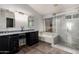 Bathroom featuring dual sinks, tub, separate shower, and window for natural light at 632 W Natal Cir, Mesa, AZ 85210