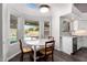Bright breakfast nook with a round table, surrounded by windows overlooking the pool at 632 W Natal Cir, Mesa, AZ 85210