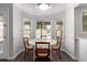Cozy breakfast nook with a round table, showcasing pool views from the bay windows at 632 W Natal Cir, Mesa, AZ 85210
