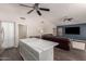 Modern kitchen featuring a sleek island, stainless steel appliances, and an open layout to the living area at 632 W Natal Cir, Mesa, AZ 85210