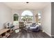 Cozy living area with a rocking chair and arched windows providing natural light at 632 W Natal Cir, Mesa, AZ 85210