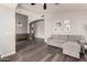 Open-concept living room featuring wood floors, recessed lighting, and a comfortable gray sectional couch at 632 W Natal Cir, Mesa, AZ 85210