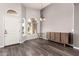 Bright and spacious living room with arched windows and a modern chandelier at 632 W Natal Cir, Mesa, AZ 85210