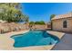 Inviting backyard pool with a rock feature, surrounded by a spacious patio area for entertaining at 632 W Natal Cir, Mesa, AZ 85210