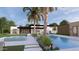 Beautiful pool area with swaying palm trees, inviting lounge chairs, and immaculate landscaping at 7001 E Paradise Dr, Scottsdale, AZ 85254