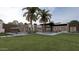 Beautiful backyard oasis with a sparkling pool, lounge chairs, and lush palm trees for relaxation at 7001 E Paradise Dr, Scottsdale, AZ 85254