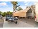 Metal carport provides covered storage for a trailer and bikes, alongside the RV, offering secure parking solutions at 7240 W Grovers Ave, Glendale, AZ 85308