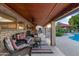 Inviting covered patio with comfortable seating, ceiling fans, and views of the pool area, perfect for outdoor relaxation at 7240 W Grovers Ave, Glendale, AZ 85308