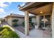 Welcoming front entrance with a charming door, brick accents, desert landscaping, and a cozy sitting area at 7240 W Grovers Ave, Glendale, AZ 85308