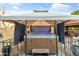Close-up of a hot tub under a gazebo, featuring blue lights, creating a spa-like experience at home at 7240 W Grovers Ave, Glendale, AZ 85308