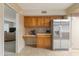 Inviting kitchen with stainless steel refrigerator and adjacent living area at 7240 W Grovers Ave, Glendale, AZ 85308