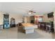 Bright living room with bar, billiards table and a decorative fireplace at 7240 W Grovers Ave, Glendale, AZ 85308